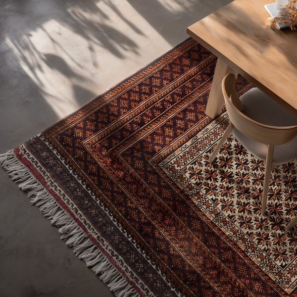 Nomadic rug with traditional oriental pattern in a stylish dining room