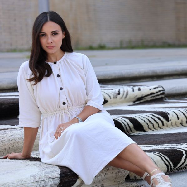 Ela, the designer, and her exclusive Berber rug in brown and white tones.