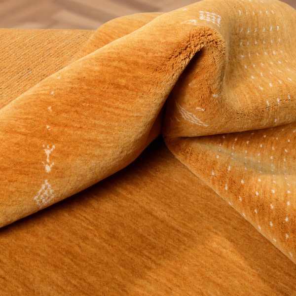 Handmade yellow designer rug with fine details and a textured surface