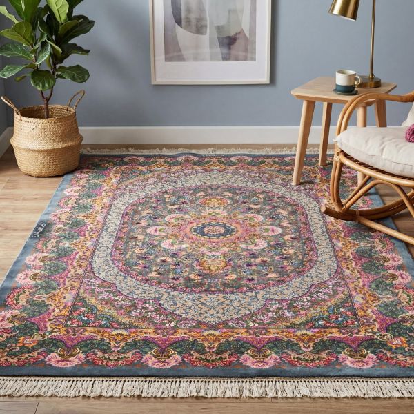 Alfombra oriental colorida con motivos florales en un salón luminoso con sillón de ratán.