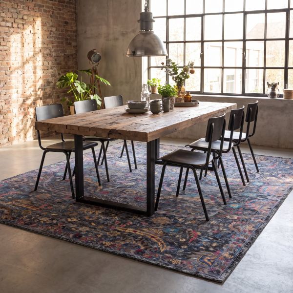 Industrial dining area with rustic wooden table and grey designer rug Mila Charm