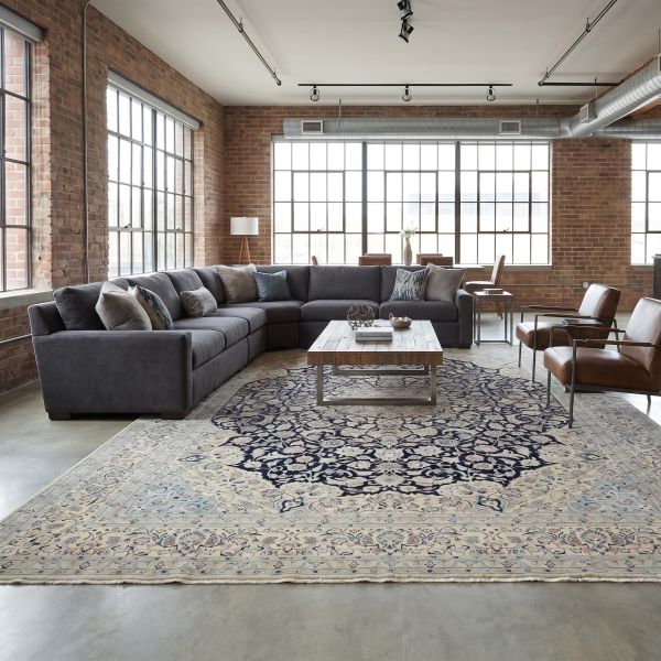 Modern living room in industrial style with dark hand-knotted Mila Feel rug made of wool and viscose