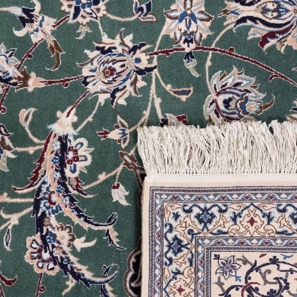 Close-up of a hand-knotted oriental rug with fringe and high-quality craftsmanship