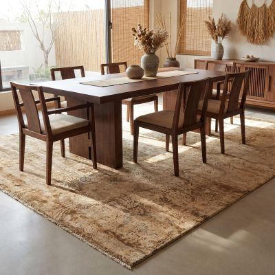 A Japandi dining room with a light brown designer rug.
