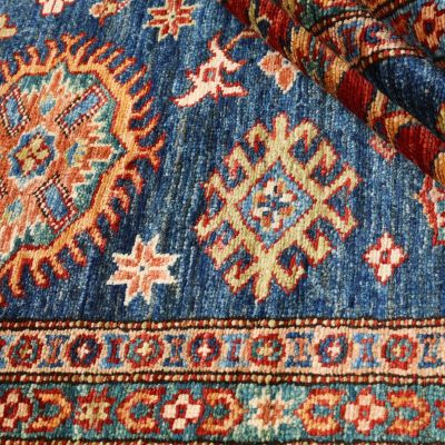Kazak rug in blue with geometric Caucasian patterns and oriental design