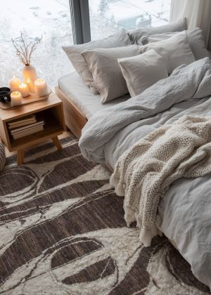 A modern designer rug in a bedroom.