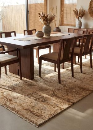 A Sindhi designer rug in a Japandi-style dining room, combining traditional patterns with minimal