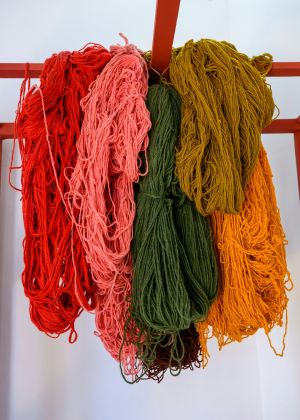 Dyed wool yarn that hangs loosely and is slightly twisted.