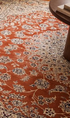 Classic hand-knotted Persian rug with a floral pattern in terracotta and cream