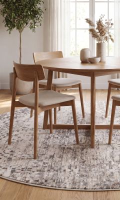 Round vintage rug in the dining room with a modern dining table