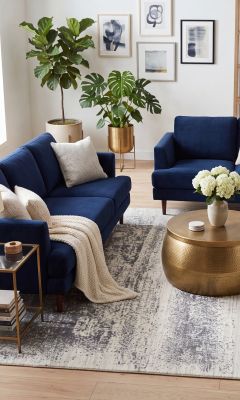 Modern designer rug in a living room with velvet furniture.