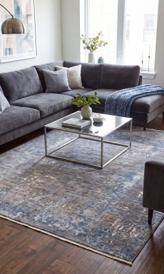Modern designer Mahra rug in a living room with velvet furniture.
